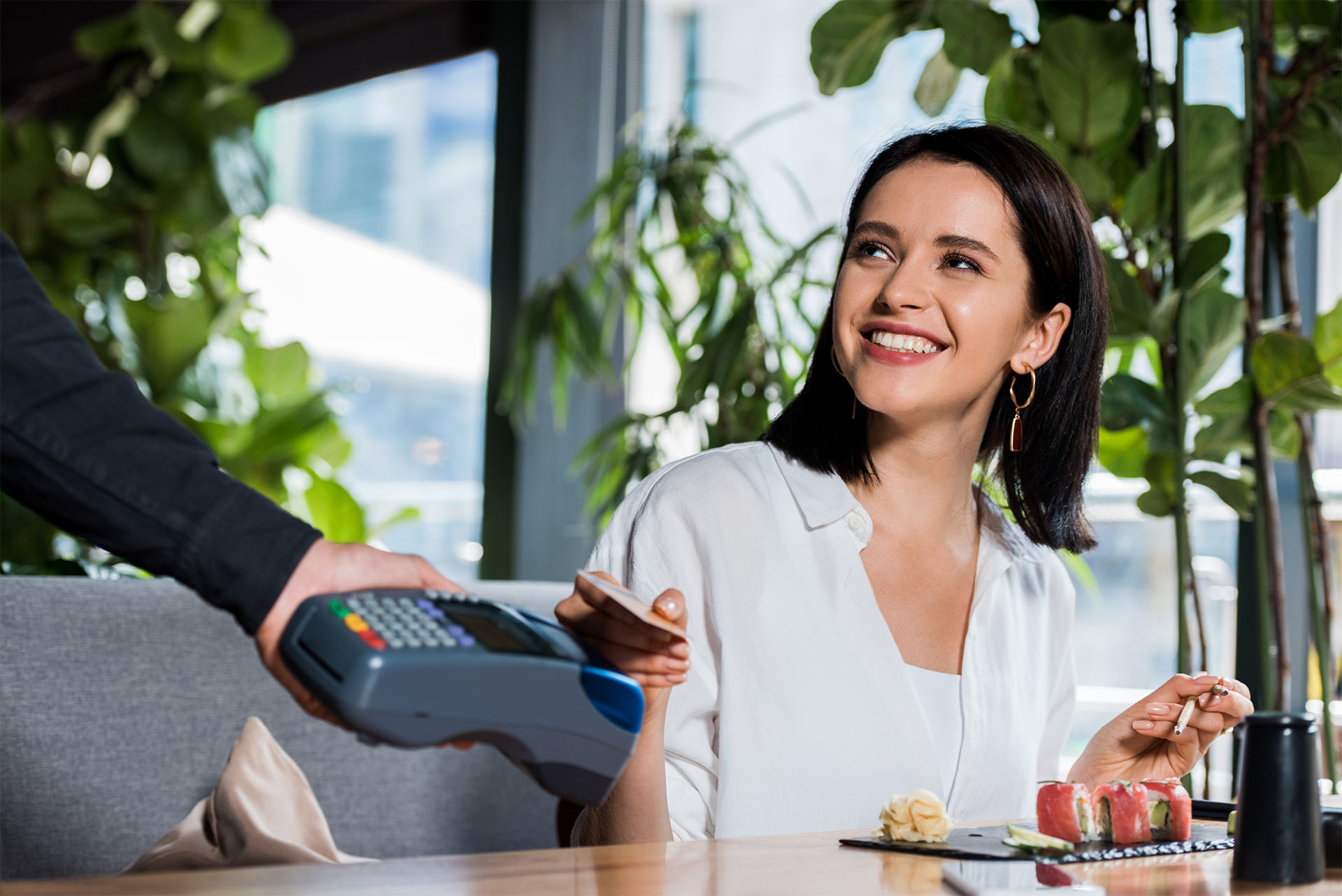 cropped-view-of-waiter-holding-credit-card-reader-2023-11-27-05-07-08-utc